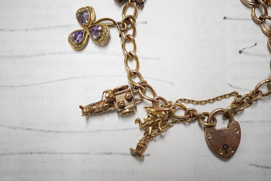 A 9ct gold curb link charm bracelet, hung with ten assorted 9ct gold and yellow metal charms including enamelled R.A.F. charm and a pixie on a toadstool, approximately 14cm, gross weight 31 grams.
